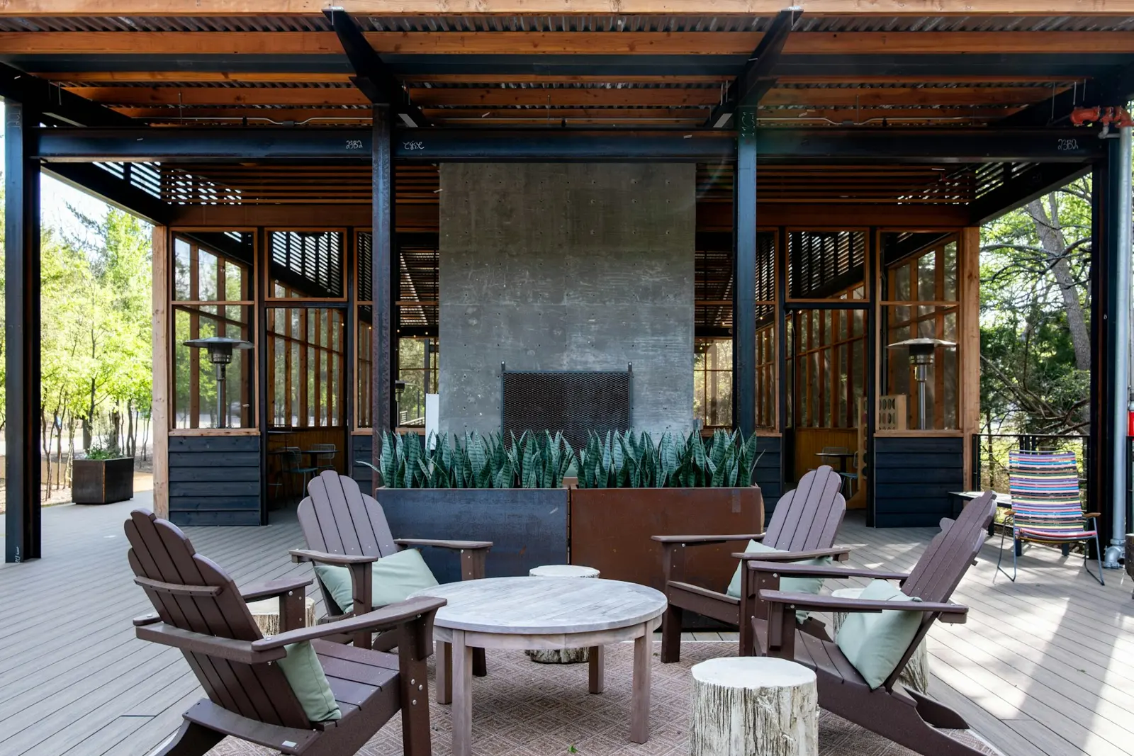 Outdoor patio fireplace with chairs around it